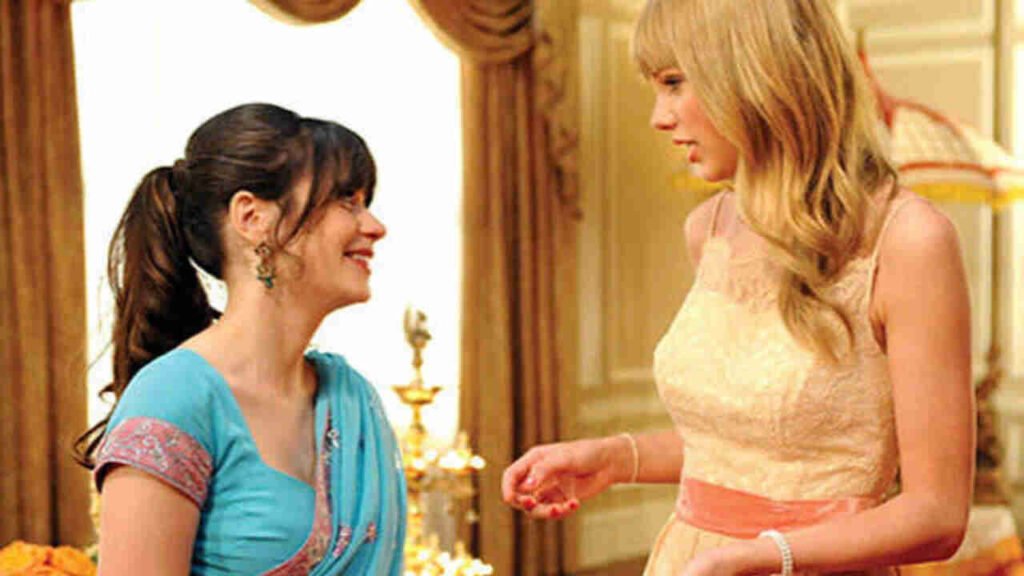 Famosos na TV: Participações especiais em séries que você pode ter deixado passar 6 Participação especial de Taylor Swift conversando com a protagonista Zooey Deschanel em cena de casamento na série de comédia New Girl. A imagem promocional destacando a presença de grandes estrelas da música pop e momentos marcantes da televisão é excelente para ilustrar críticas de episódios, listas de participações icônicas e artigos de entretenimento no site.