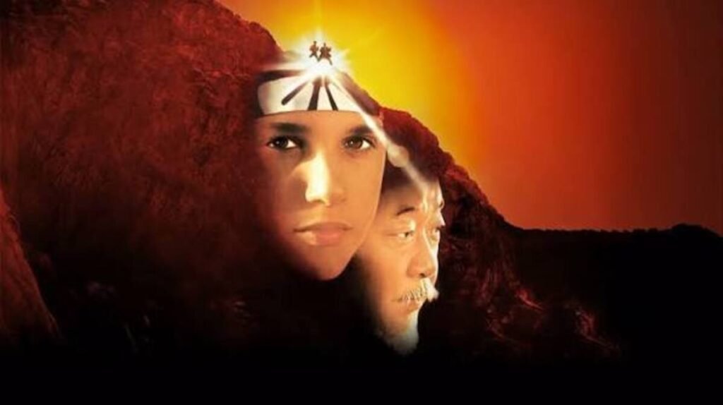 Pôster clássico de Karate Kid III mostrando Daniel LaRusso com bandana hachimaki e o Senhor Miyagi integrados a um cenário de montanhas ao pôr do sol.